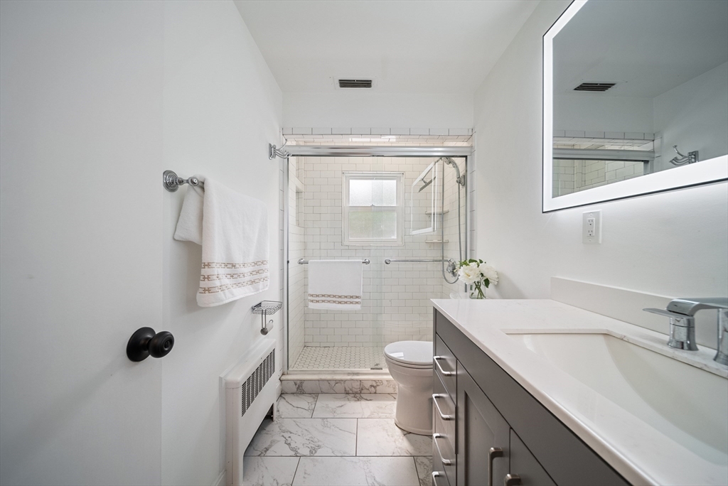 123 Walnut Street Saugus, MA 01906 - Photo 22 of 38 a bathroom with a granite countertop sink a toilet and shower