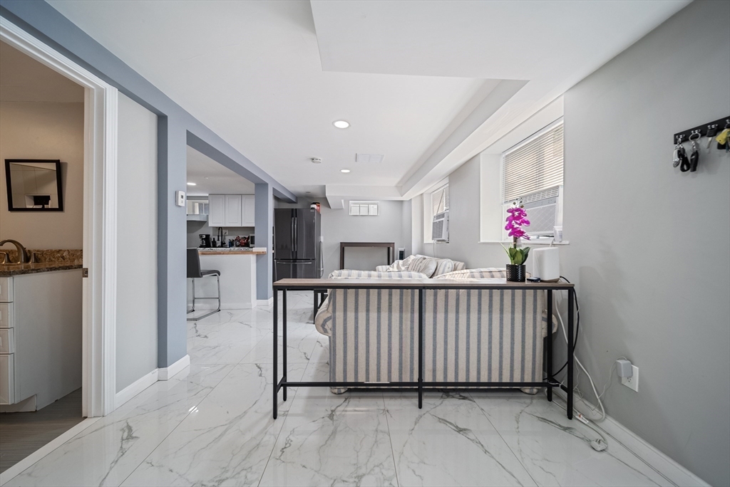 123 Walnut Street Saugus, MA 01906 - Photo 28 of 38 a view of a hallway with dining room and wooden floor