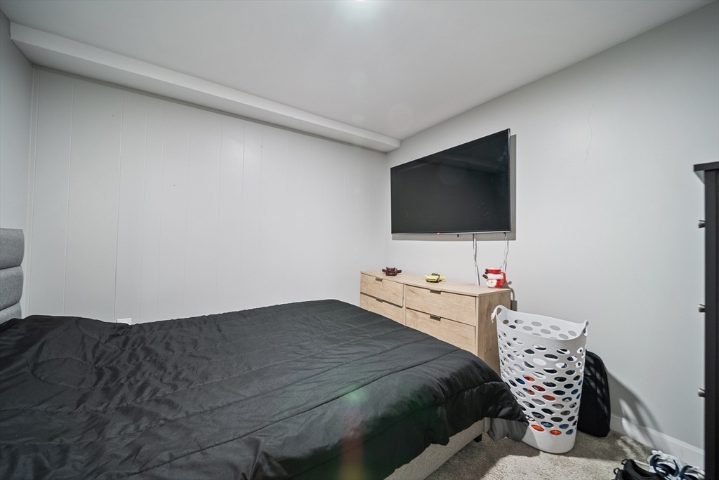 123 Walnut Street Saugus, MA 01906 - Photo 30 of 38 a bedroom with a bed and a flat screen tv
