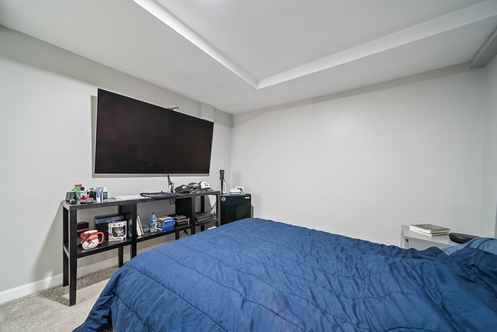 123 Walnut Street Saugus, MA 01906 - Photo 31 of 38 a bedroom with a bed and a flat screen tv