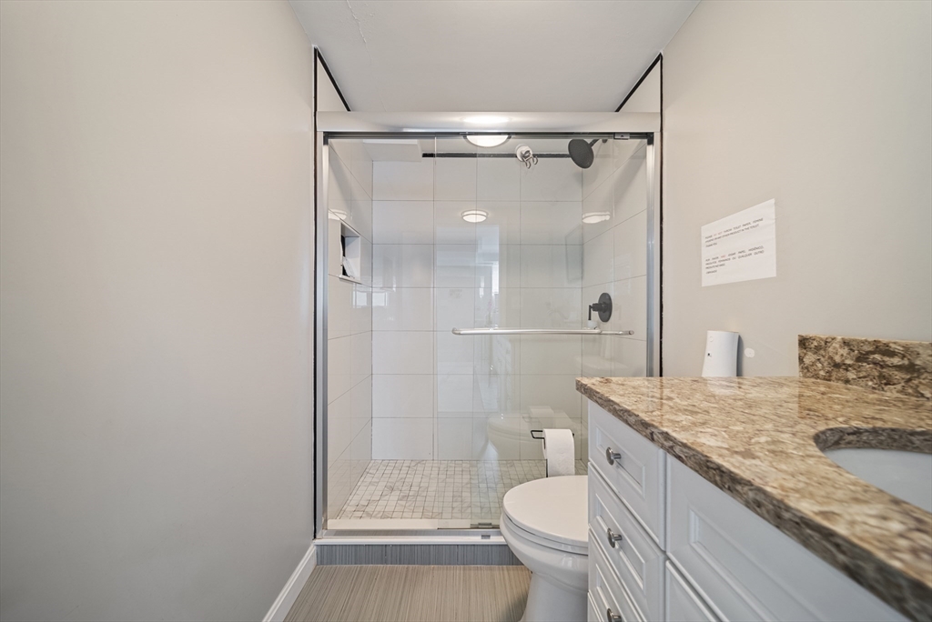 123 Walnut Street Saugus, MA 01906 - Photo 33 of 38 a bathroom with a granite countertop sink toilet and shower