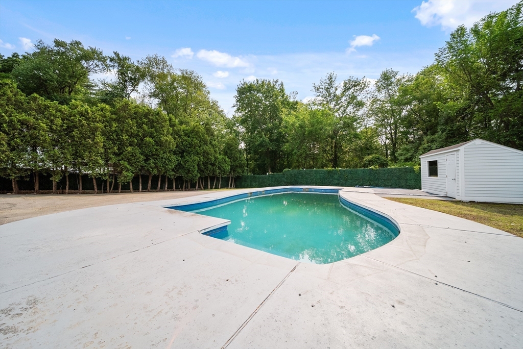 123 Walnut Street Saugus, MA 01906 - Photo 34 of 38 a view of a swimming pool with an outdoor space and seating area