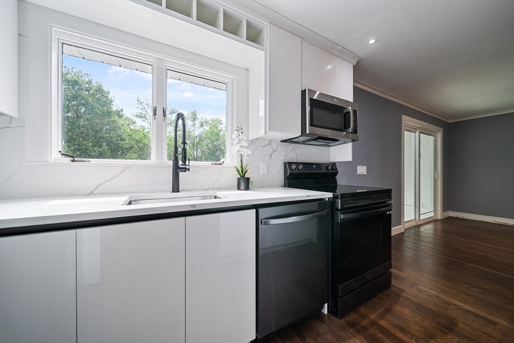 123 Walnut Street Saugus, MA 01906 - Photo 7 of 38 a kitchen with stainless steel appliances granite countertop a sink and a microwave