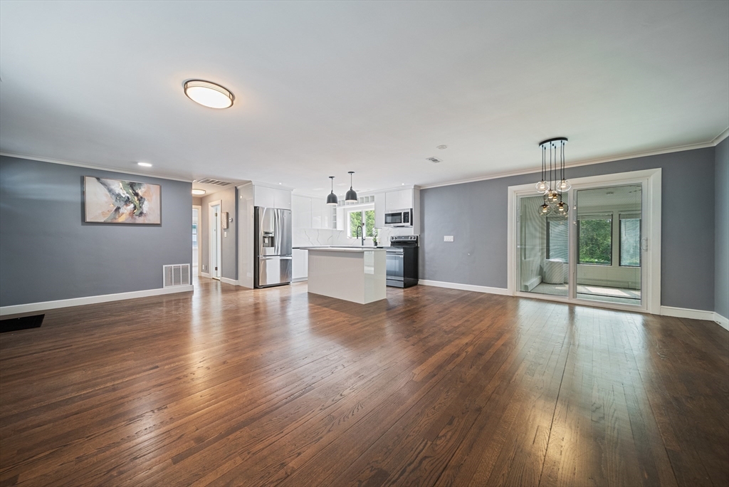 123 Walnut Street Saugus, MA 01906 - Photo 10 of 38 a view of an empty room with wooden floor and a window