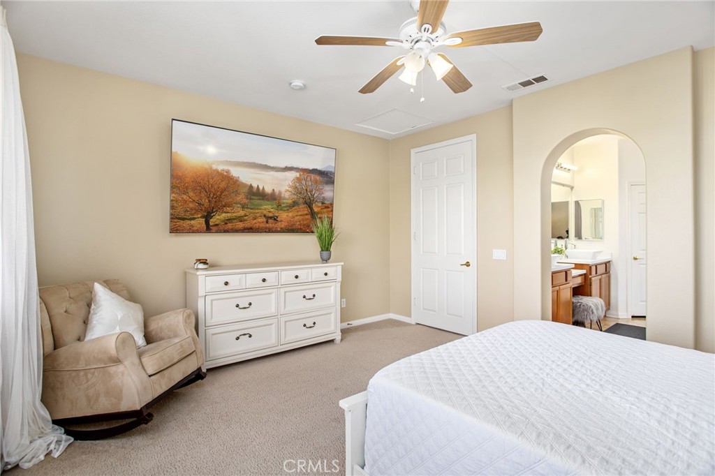 84146 Olona Court Indio, CA 92203 - Photo 12 of 35 a bedroom with a bed and a chandelier