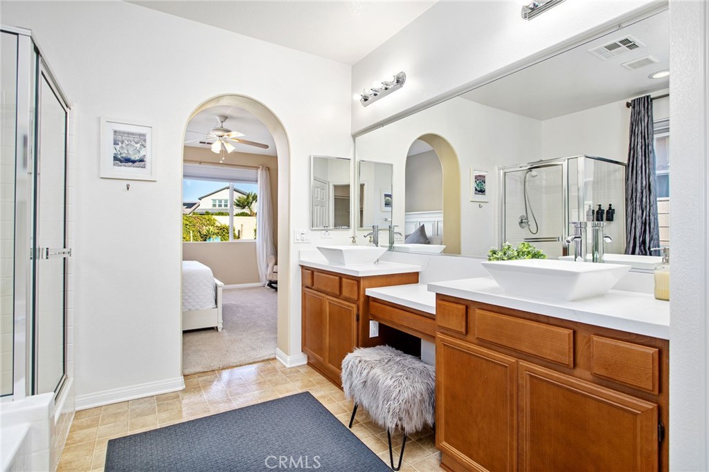 84146 Olona Court Indio, CA 92203 - Photo 13 of 35 a spacious bathroom with a granite countertop sink mirror and bathtub