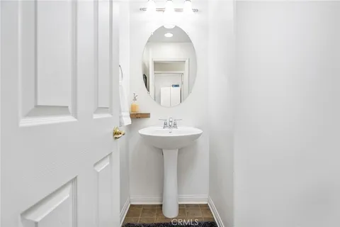 a bathroom with a sink a mirror and vanity