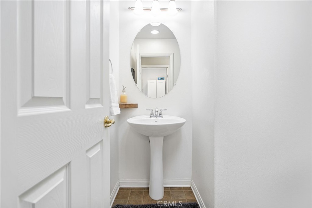 84146 Olona Court Indio, CA 92203 - Photo 17 of 35 a bathroom with a sink a mirror and vanity
