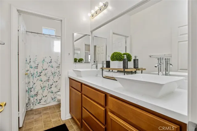 a bathroom with a sink a mirror and a shower