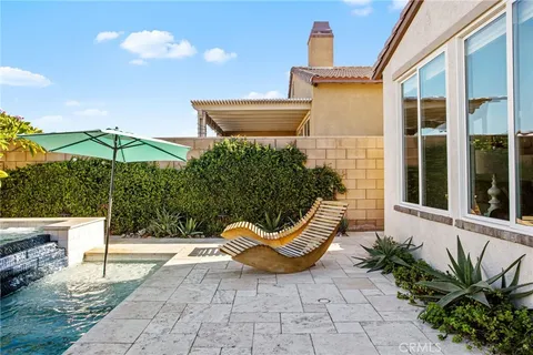 a view of a chair and fire pit in the patio with a backyard