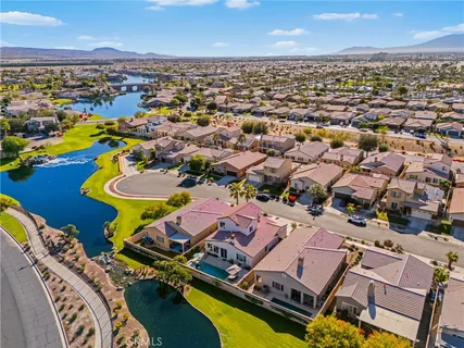 an aerial view of a house with a swimming pool outdoor seating and mountain view