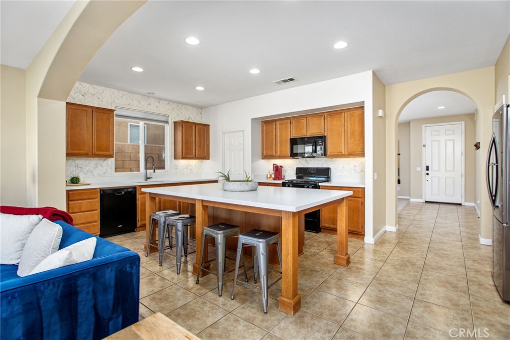 84146 Olona Court Indio, CA 92203 - Photo 6 of 35 a kitchen with stainless steel appliances granite countertop a stove a sink and a refrigerator