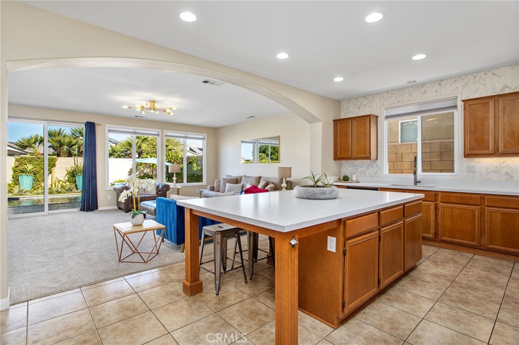 84146 Olona Court Indio, CA 92203 - Photo 7 of 35 a large kitchen with kitchen island a large window in it
