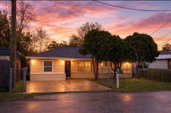 a view of backyard of house with green space