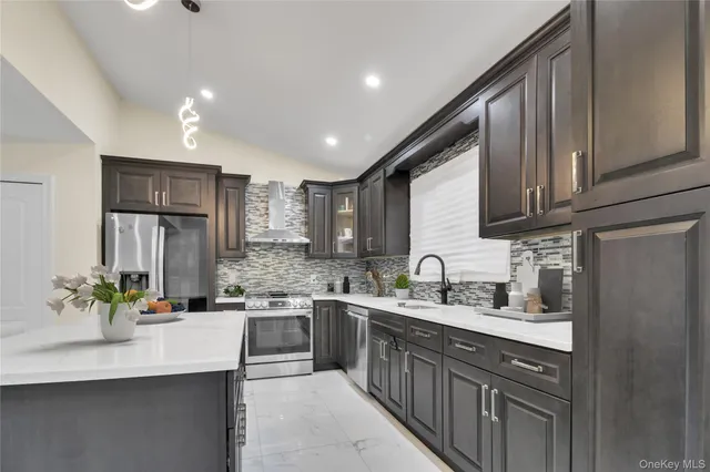 a kitchen with stainless steel appliances granite countertop a sink stove and refrigerator
