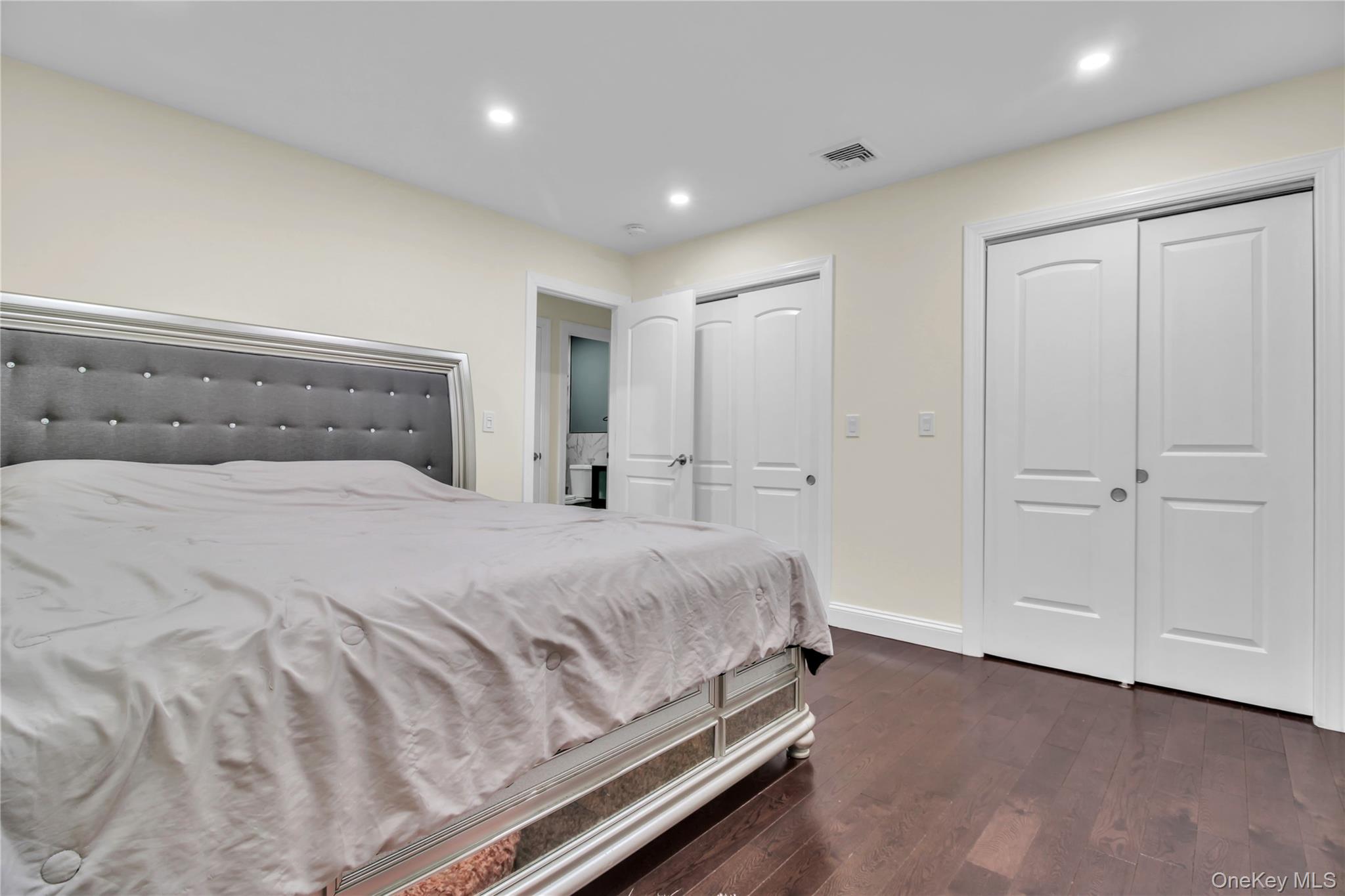 858 Prescott Street Valley Stream, NY 11580 - Photo 19 of 48 Bedroom with multiple closets, dark wood finished floors, and recessed lighting