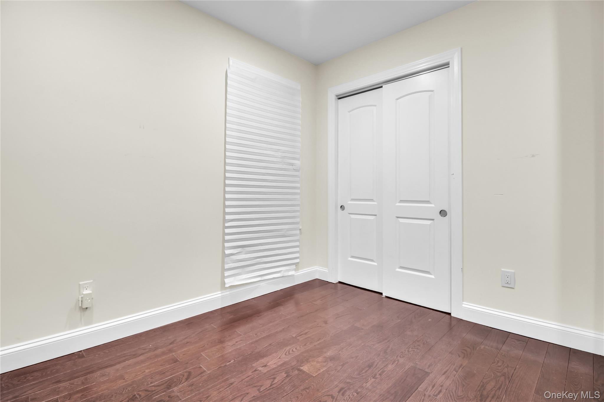 858 Prescott Street Valley Stream, NY 11580 - Photo 20 of 48 Unfurnished bedroom featuring dark wood-style flooring and a closet