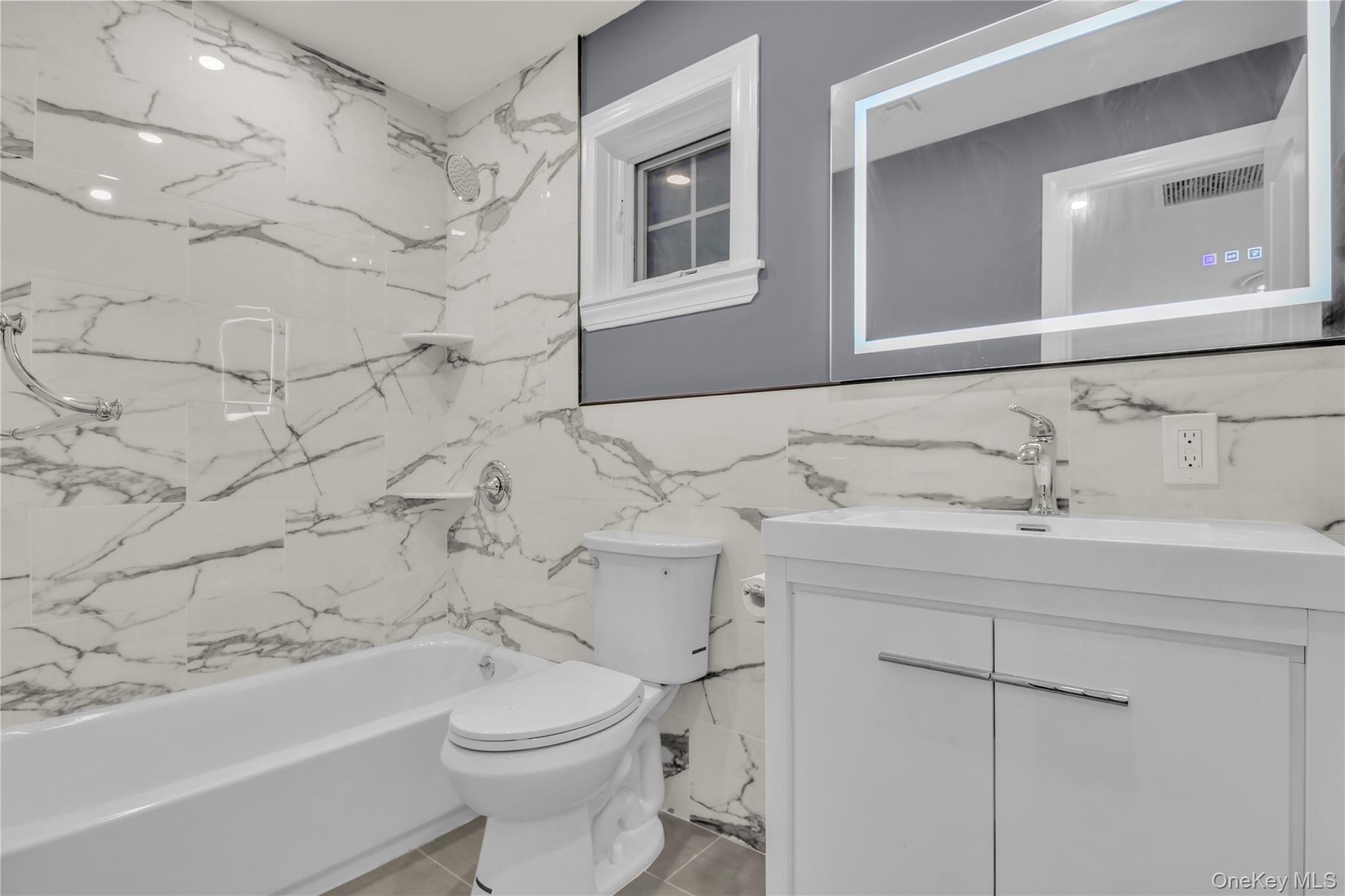 858 Prescott Street Valley Stream, NY 11580 - Photo 22 of 48 Bathroom featuring vanity and a combined bath / shower with marble appearance