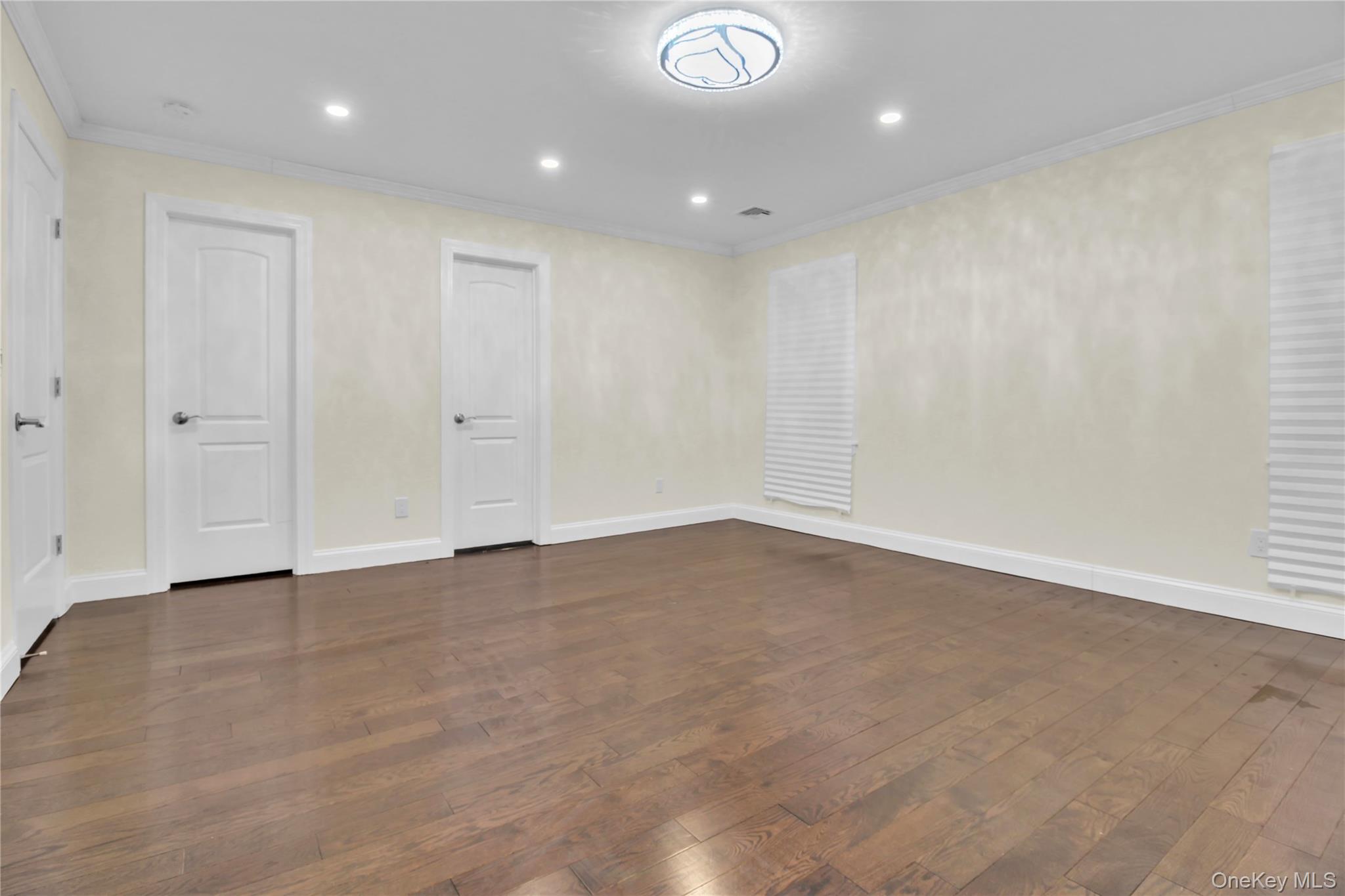 858 Prescott Street Valley Stream, NY 11580 - Photo 28 of 48 Unfurnished room with recessed lighting, dark wood-style flooring, and crown molding