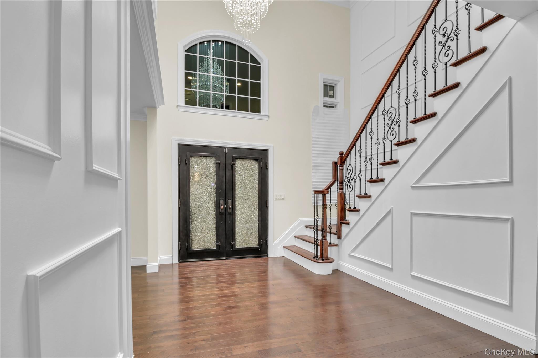 858 Prescott Street Valley Stream, NY 11580 - Photo 3 of 48 Foyer entrance with a chandelier, stairway, dark wood finished floors, and a high ceiling