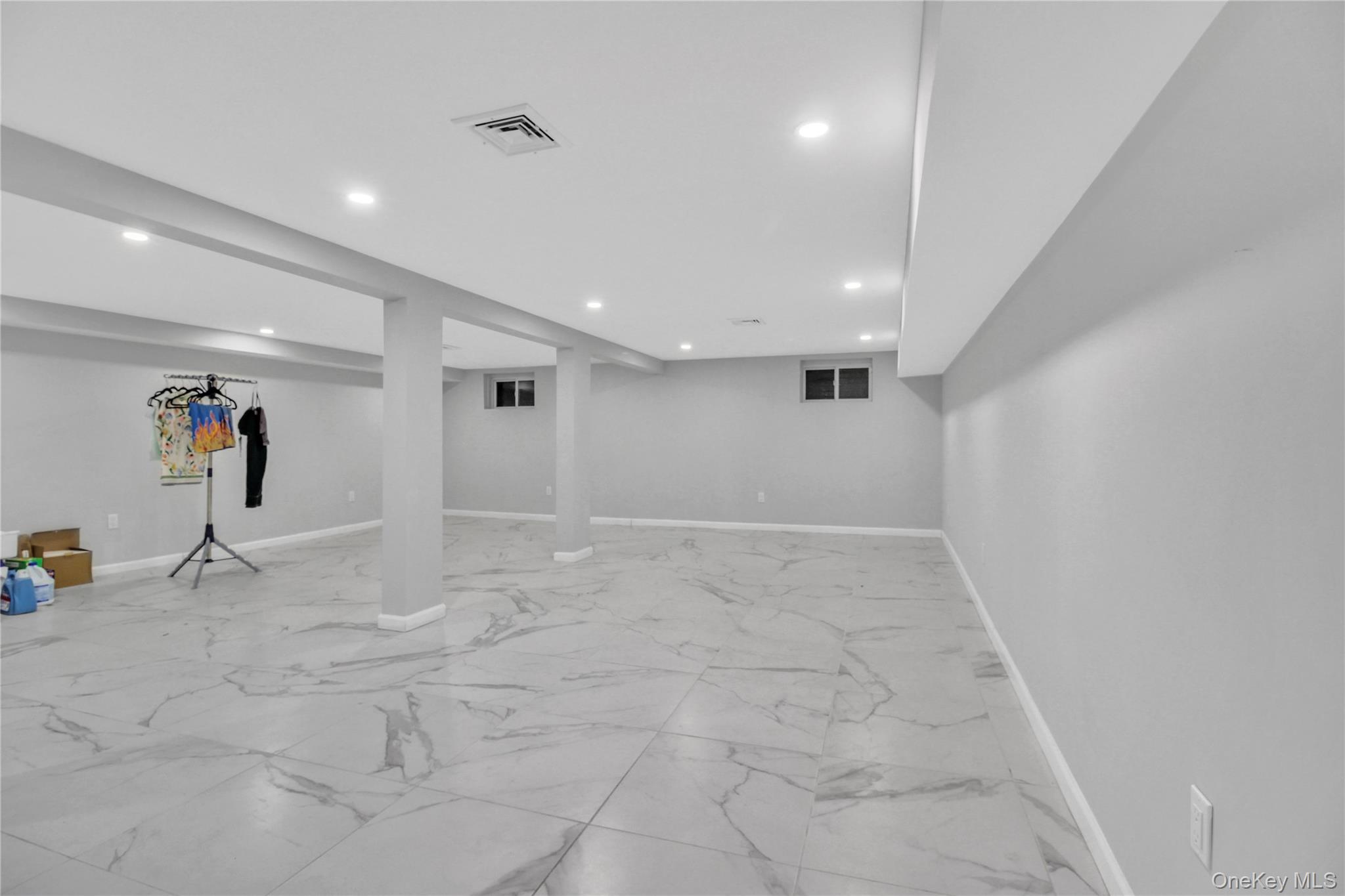 858 Prescott Street Valley Stream, NY 11580 - Photo 37 of 48 Finished below grade area with light marble finish floors and recessed lighting