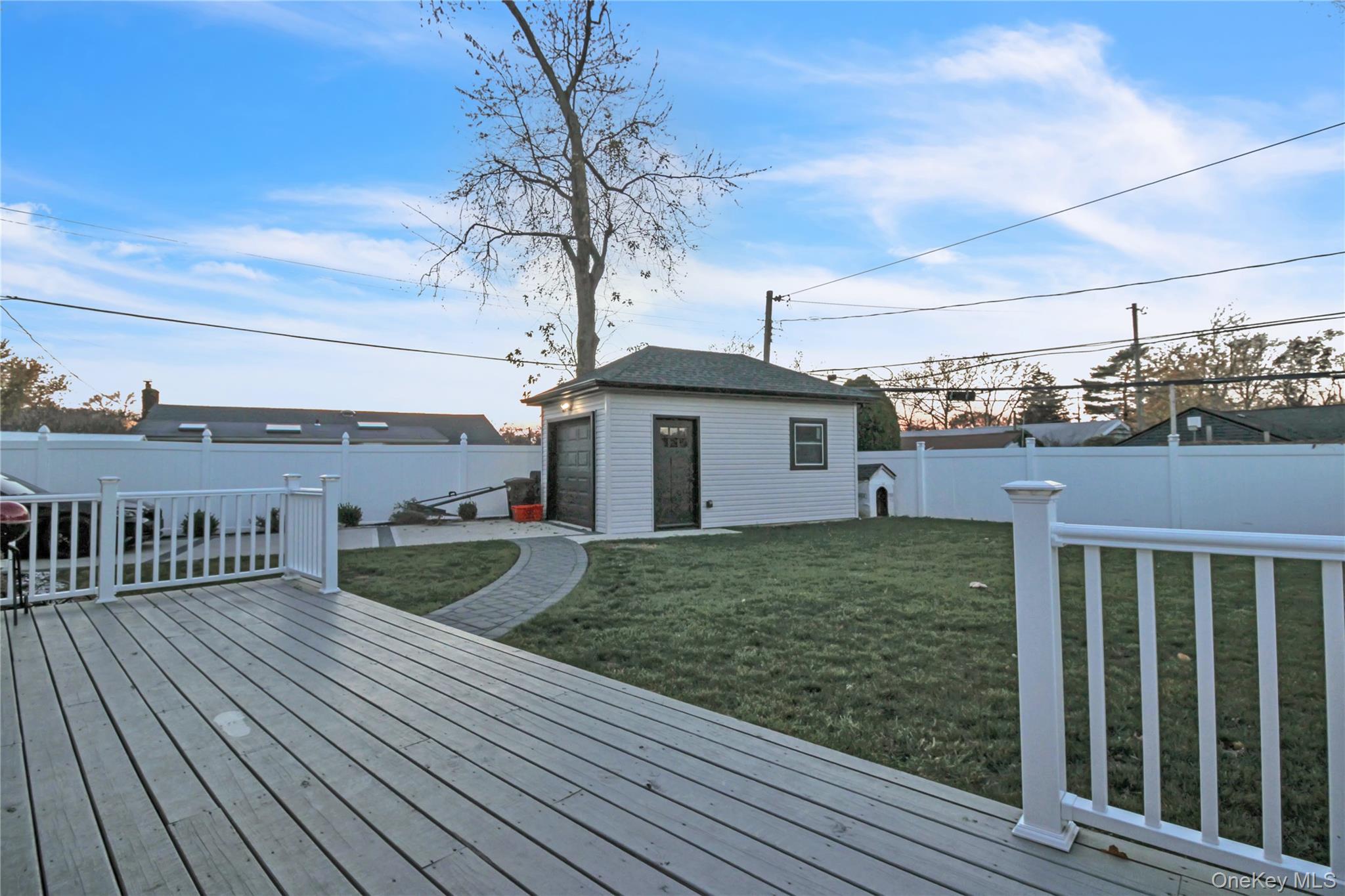 858 Prescott Street Valley Stream, NY 11580 - Photo 39 of 48 Wooden terrace with an outdoor structure and a fenced backyard