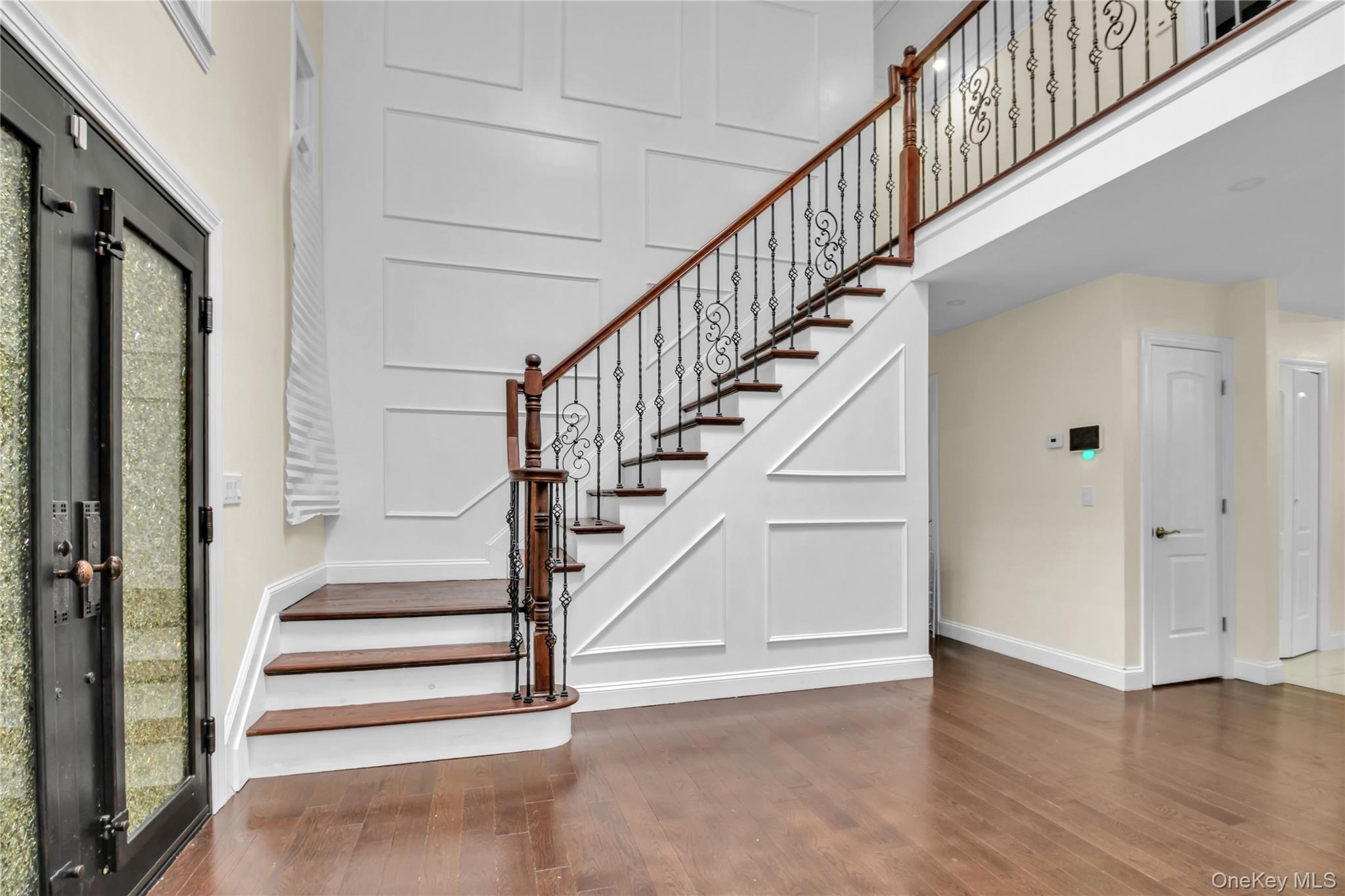 858 Prescott Street Valley Stream, NY 11580 - Photo 4 of 48 Staircase with wood finished floors and a decorative wall