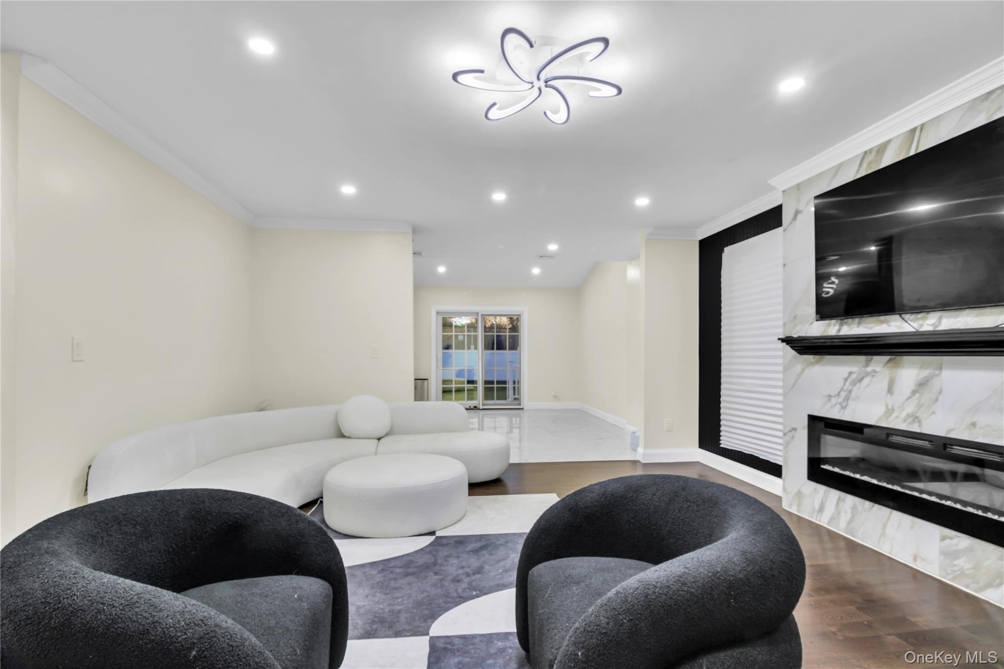 858 Prescott Street Valley Stream, NY 11580 - Photo 9 of 48 Living room featuring recessed lighting, wood finished floors, ornamental molding, and a premium fireplace