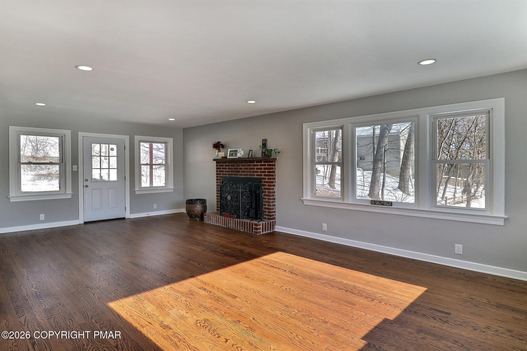 230 Colbert Street Stroudsburg, PA 18360 - Photo 16 of 43 an empty room with wooden floor fireplace and windows