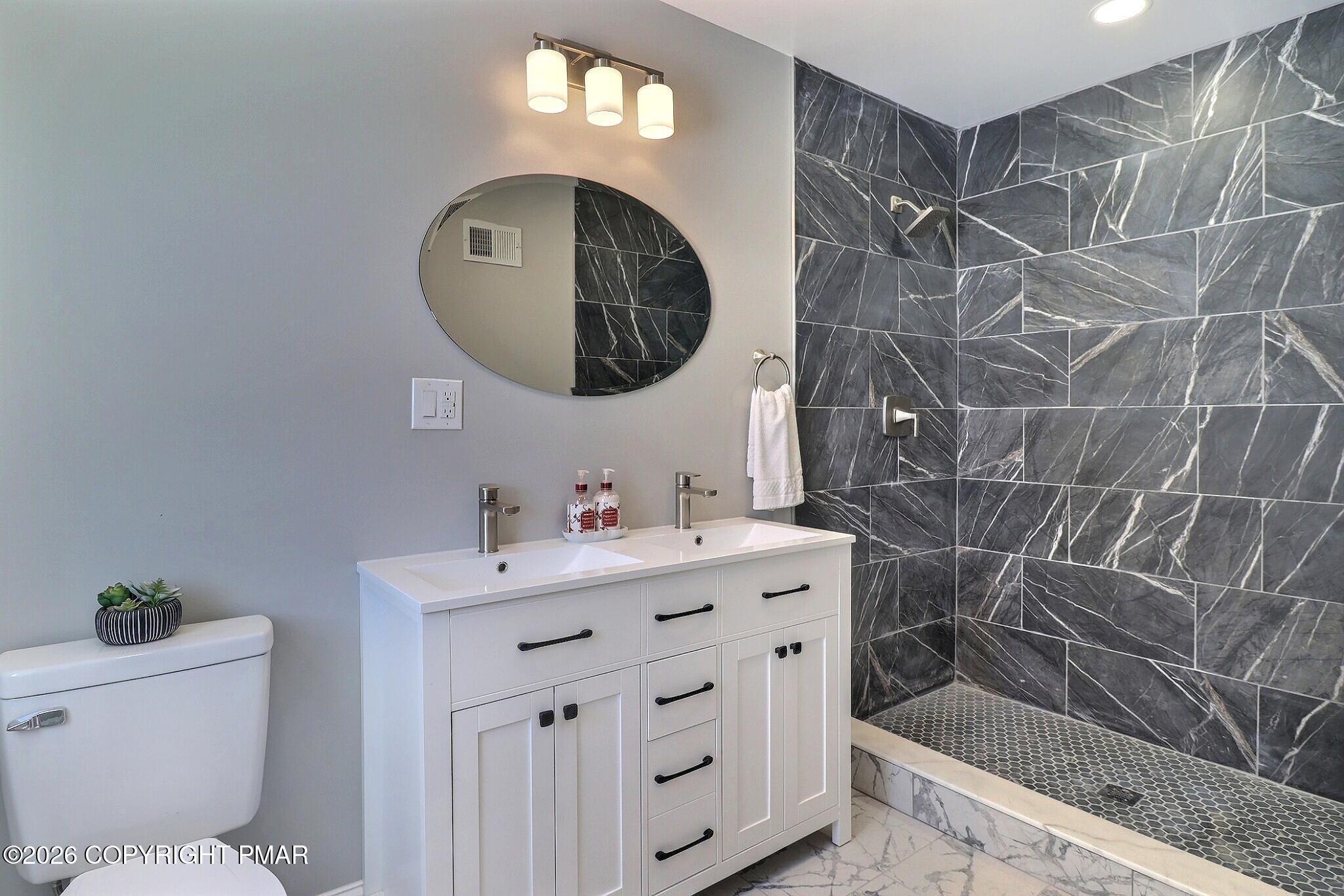 230 Colbert Street Stroudsburg, PA 18360 - Photo 25 of 43 a bathroom with a sink a toilet and a mirror