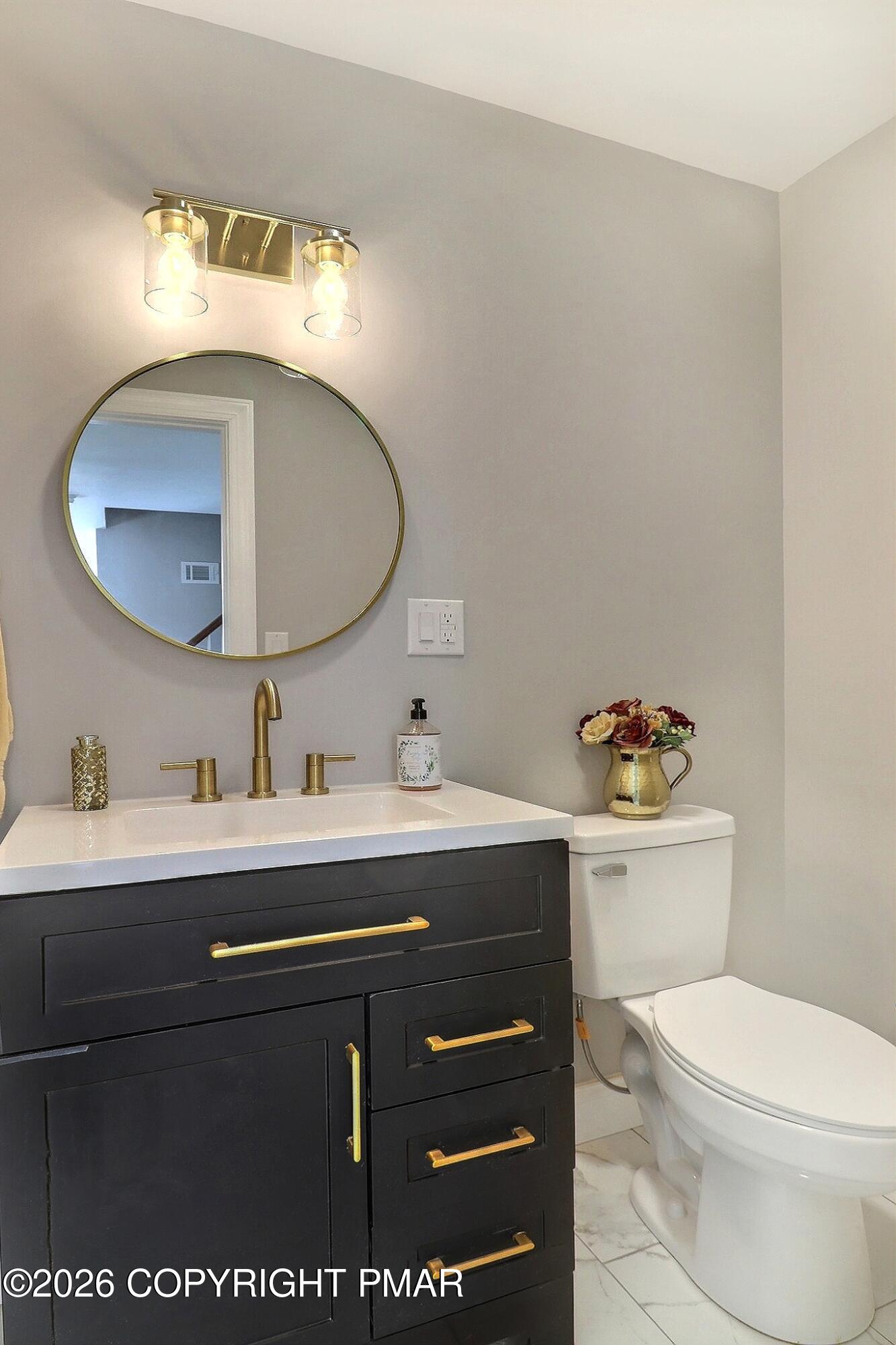 230 Colbert Street Stroudsburg, PA 18360 - Photo 28 of 43 a bathroom with a toilet sink vanity and mirror