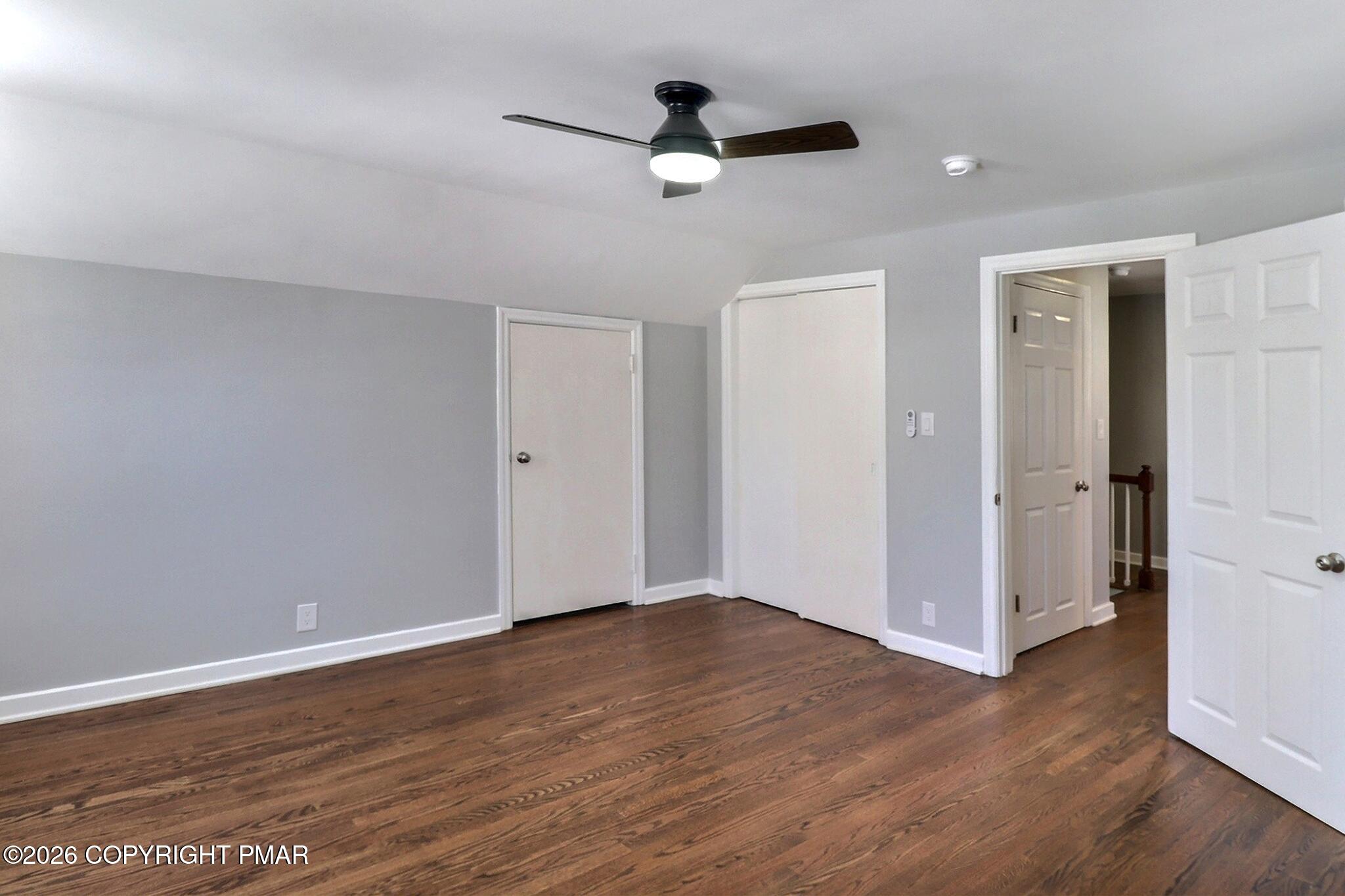 230 Colbert Street Stroudsburg, PA 18360 - Photo 30 of 43 an empty room with wooden floor and a ceiling fan