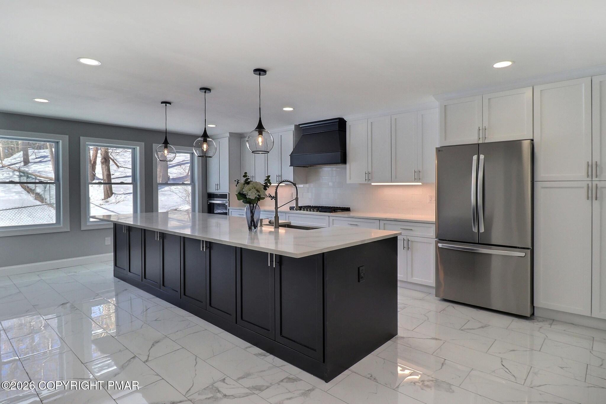 230 Colbert Street Stroudsburg, PA 18360 - Photo 9 of 43 a kitchen with stainless steel appliances a sink and a refrigerator