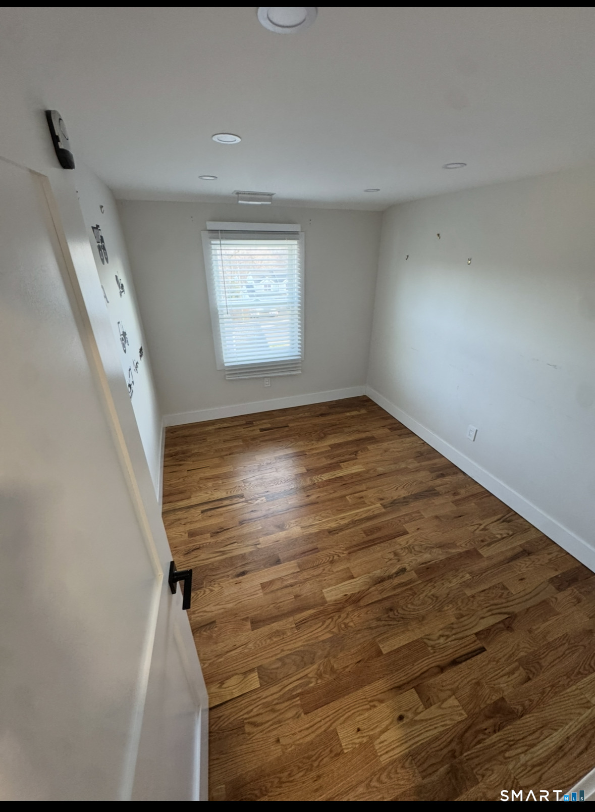 35 Knapps Highway Fairfield, CT 06825 - Photo 19 of 21 a view of an empty room with wooden floor and a window
