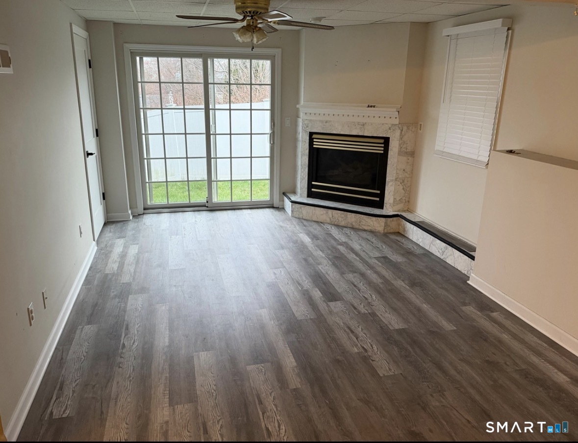 35 Knapps Highway Fairfield, CT 06825 - Photo 21 of 21 wooden floor fireplace and windows in an empty room