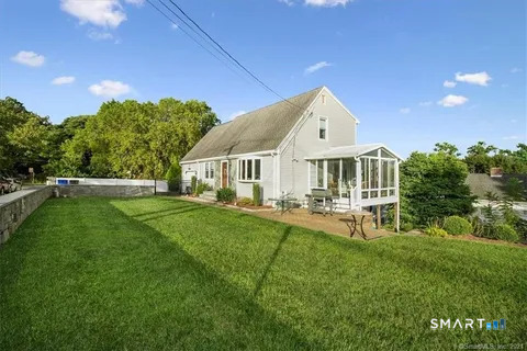 35 Knapps Highway Fairfield, CT 06825 - Photo 3 of 21 a front view of a house with backyard and sitting area