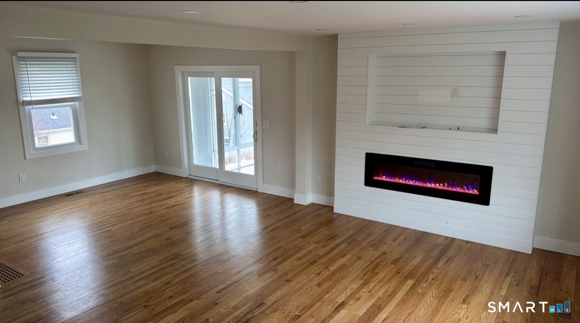 35 Knapps Highway Fairfield, CT 06825 - Photo 4 of 21 a view of an empty room with wooden floor and a window