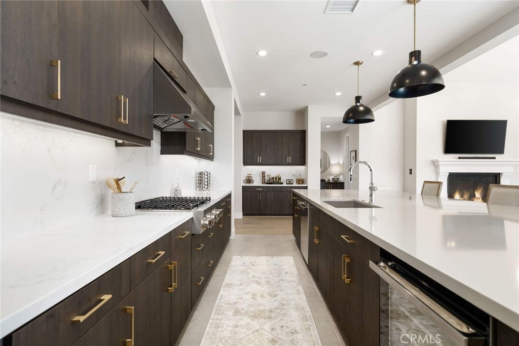 80467 Old Ranch Trail South La Quinta, CA 92253 - Photo 15 of 55 a large kitchen with stainless steel appliances lots of counter space and a sink