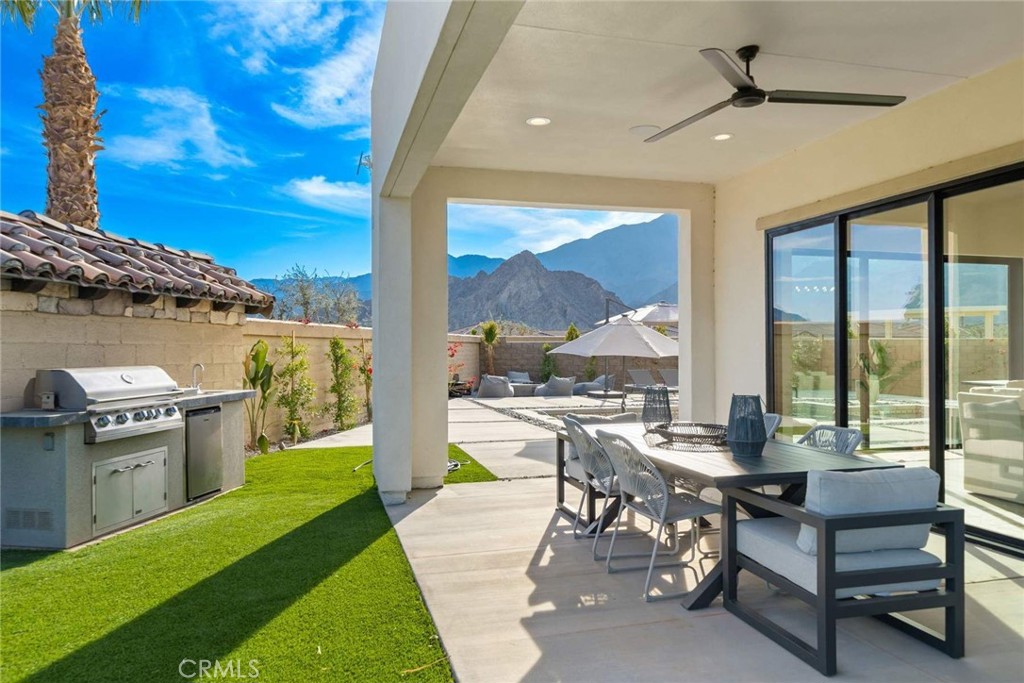 80467 Old Ranch Trail South La Quinta, CA 92253 - Photo 27 of 55 a living room with chairs a stove and a table