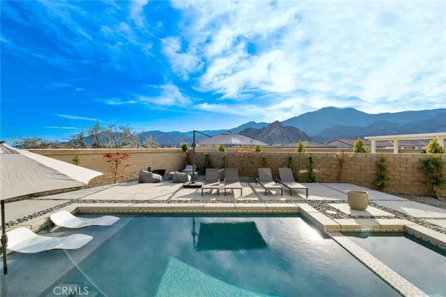 a large spacious bathroom with a double vanity sink a large mirror and a bathtub