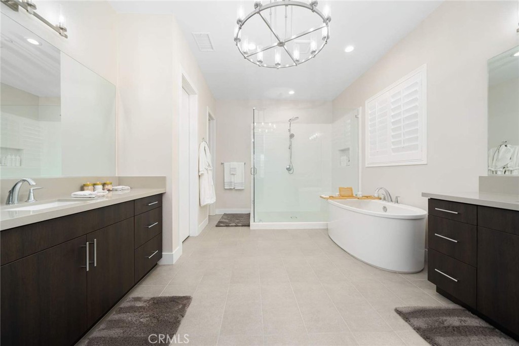 80467 Old Ranch Trail South La Quinta, CA 92253 - Photo 37 of 55 a large spacious bathroom with a double vanity sink a large mirror and a bathtub