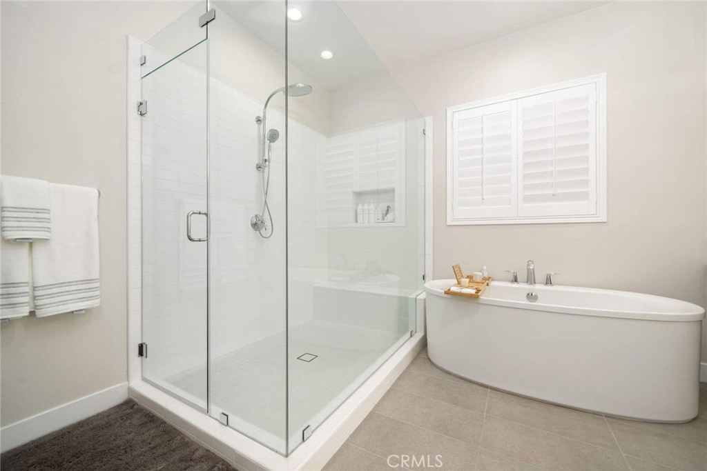 80467 Old Ranch Trail South La Quinta, CA 92253 - Photo 38 of 55 a bathroom with a bathtub a shower a sink and a window