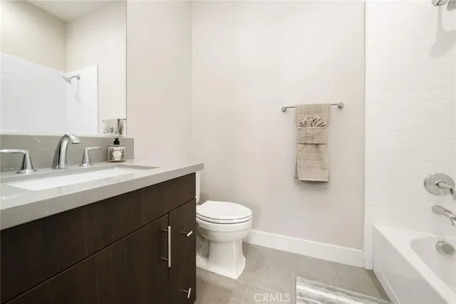 a spacious bedroom with a bed and a window