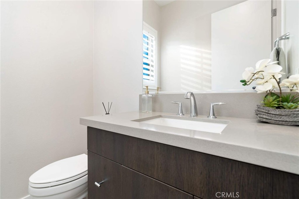 80467 Old Ranch Trail South La Quinta, CA 92253 - Photo 42 of 55 a bathroom with a sink a toilet and a mirror