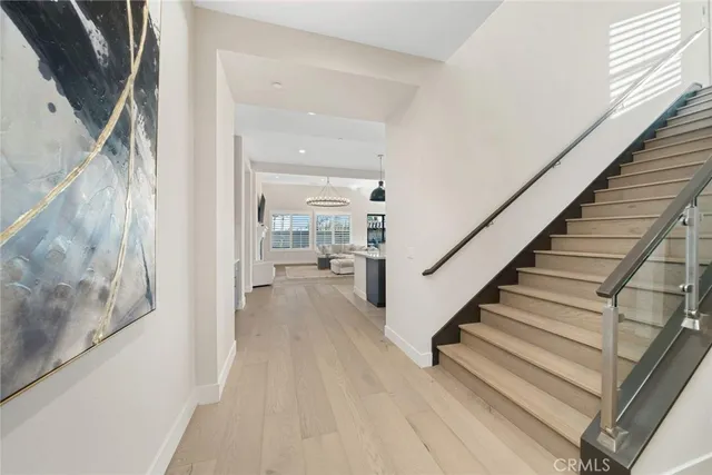 a kitchen with stainless steel appliances a stove a chandelier and a refrigerator