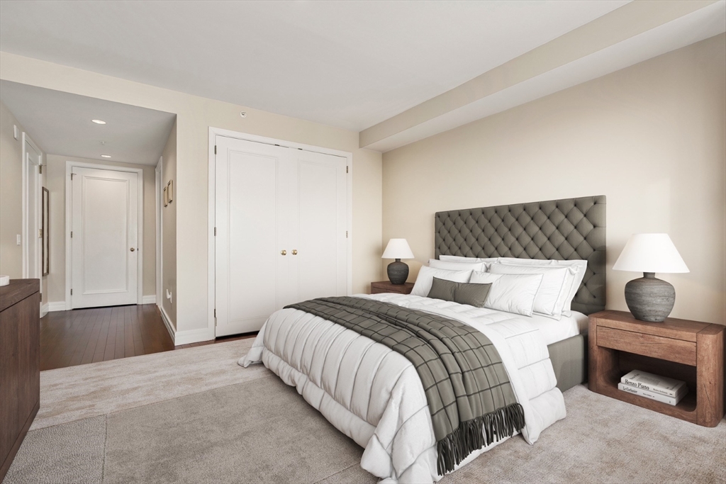1 Avery Street, Unit 16G Boston, MA 02111 - Photo 11 of 15 a bedroom with a bed and a fireplace