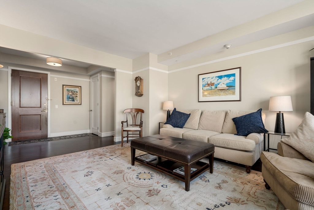 1 Avery Street, Unit 16G Boston, MA 02111 - Photo 2 of 15 a spacious bedroom with a bed a couch and lamp