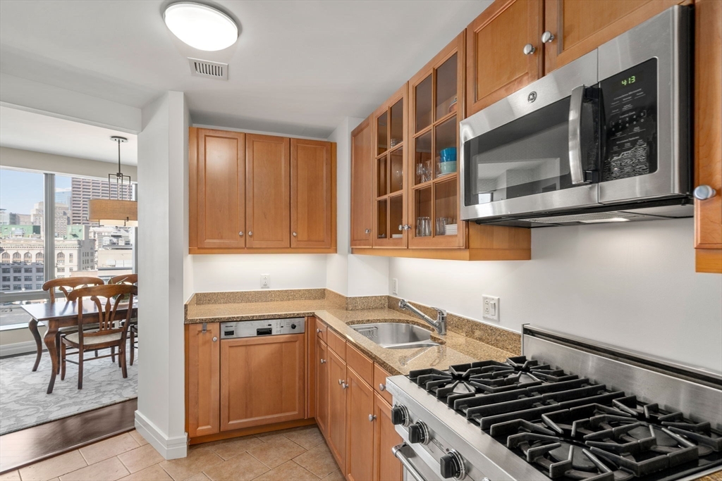 1 Avery Street, Unit 16G Boston, MA 02111 - Photo 7 of 15 a kitchen that has a sink and a stove