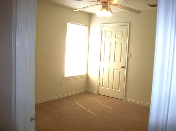 an empty room with windows and entrance