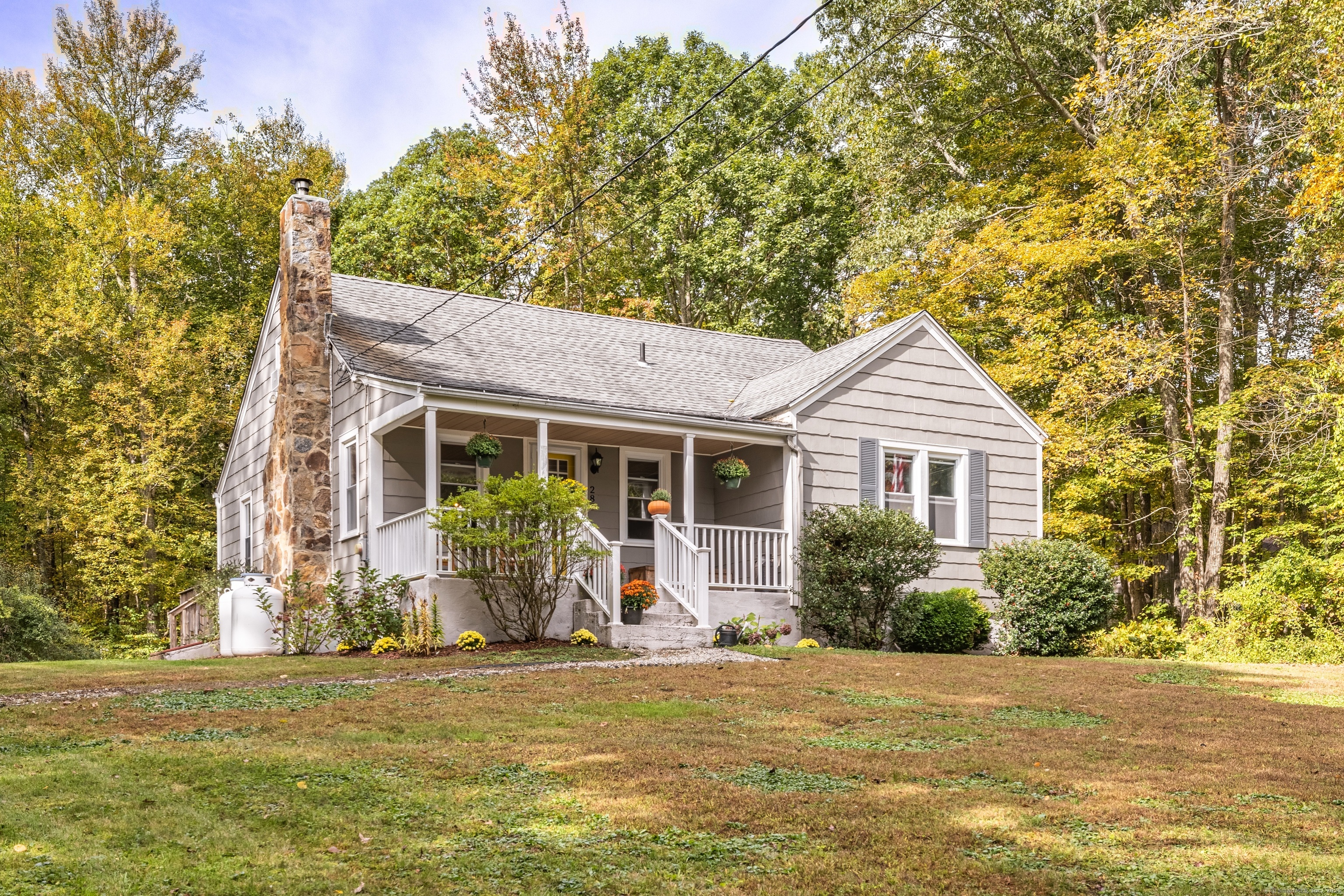 283 Tower Hill Road Chaplin, CT 06235 - Photo 1 of 1 a front view of house with yard and trees in the background